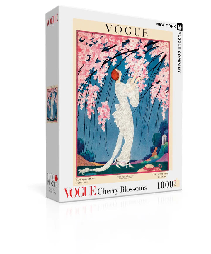 New York Puzzle Company Cherry Blossoms 1000-piece jigsaw puzzle featuring beautiful cherry blossom trees in full bloom with peaceful spring scenery and delicate pink flowers.