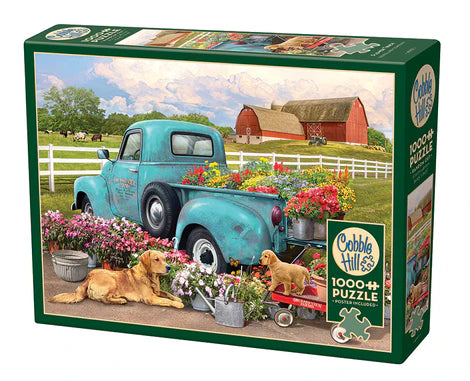 Cobble Hill Flower Truck 1000-piece jigsaw puzzle featuring a vintage truck overflowing with colorful flowers in a charming countryside setting.