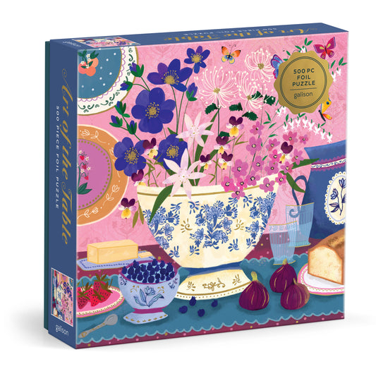 Galison Joy Laforme Art of the Table 500-piece foil jigsaw puzzle featuring an elegant tablescape with gourmet dishes, floral arrangements, and shimmering foil details.