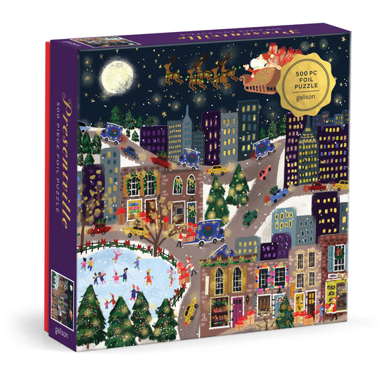 Galison Joy Laforme Presentville 500-piece foil jigsaw puzzle featuring a festive holiday town filled with colorful gift shops, Christmas decorations, and foil accents.