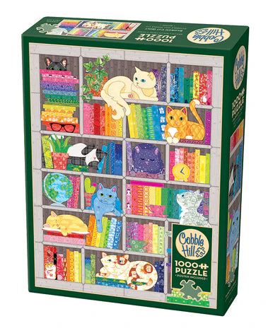 Cobble Hill Rainbow Cat Quilt 1000-piece jigsaw puzzle featuring colorful cats resting on a vibrant patchwork quilt with whimsical patterns and cheerful artwork.