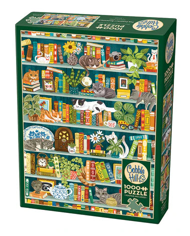 Cobble Hill The Purrfect Bookshelf 1000-piece jigsaw puzzle featuring playful cats lounging among colorful books, cozy shelves, and charming literary décor.
