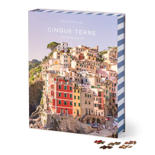Galison Gray Malin Cinque Terre 1000-piece book jigsaw puzzle featuring the colorful cliffside villages of Cinque Terre along the Italian Riviera.