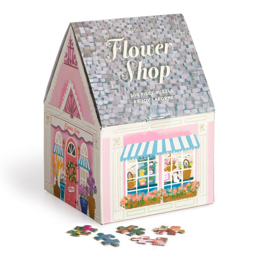 Galison Joy Laforme Flower Shop 500-piece house-shaped jigsaw puzzle featuring a charming flower shop overflowing with colorful blooms and cozy storefront details.