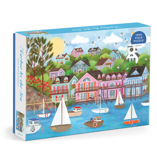 Galison Joy Laforme Harbor by the Sea 1000-piece jigsaw puzzle featuring a picturesque seaside harbor with colorful boats, charming waterfront cottages, and coastal scenery.