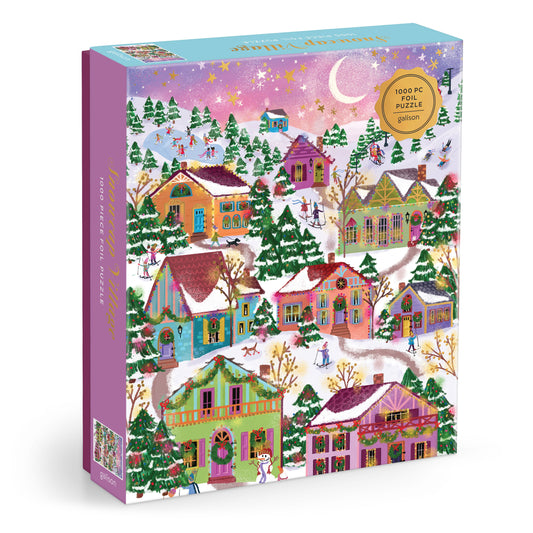 Galison Joy Laforme Snowcap Village 1000-piece foil jigsaw puzzle featuring a magical snow-covered village with sparkling foil accents, cozy homes, and festive winter scenery.