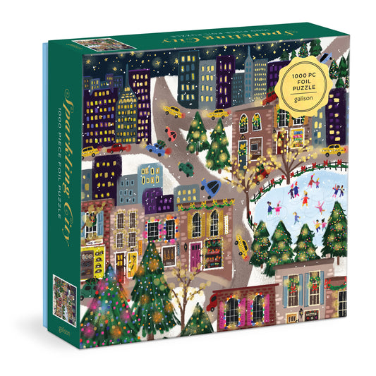 Galison Joy Laforme Sparkling City 1000-piece foil jigsaw puzzle featuring a dazzling city skyline with sparkling foil accents, colorful buildings, and vibrant urban charm.