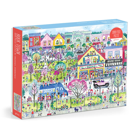 Galison Michael Storrings Book Townscape 1000-piece jigsaw puzzle featuring a whimsical town built from colorful books with charming bookstores, literary landmarks, and imaginative artwork.