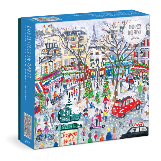 Galison Michael Storrings Christmas in Paris 1000-piece foil jigsaw puzzle featuring festive Paris streets, holiday lights, and elegant Christmas decorations with shimmering foil accents.